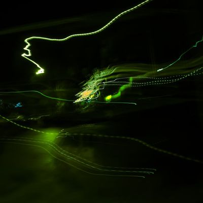 Abstract motion blur of light trails in a dark environment.
